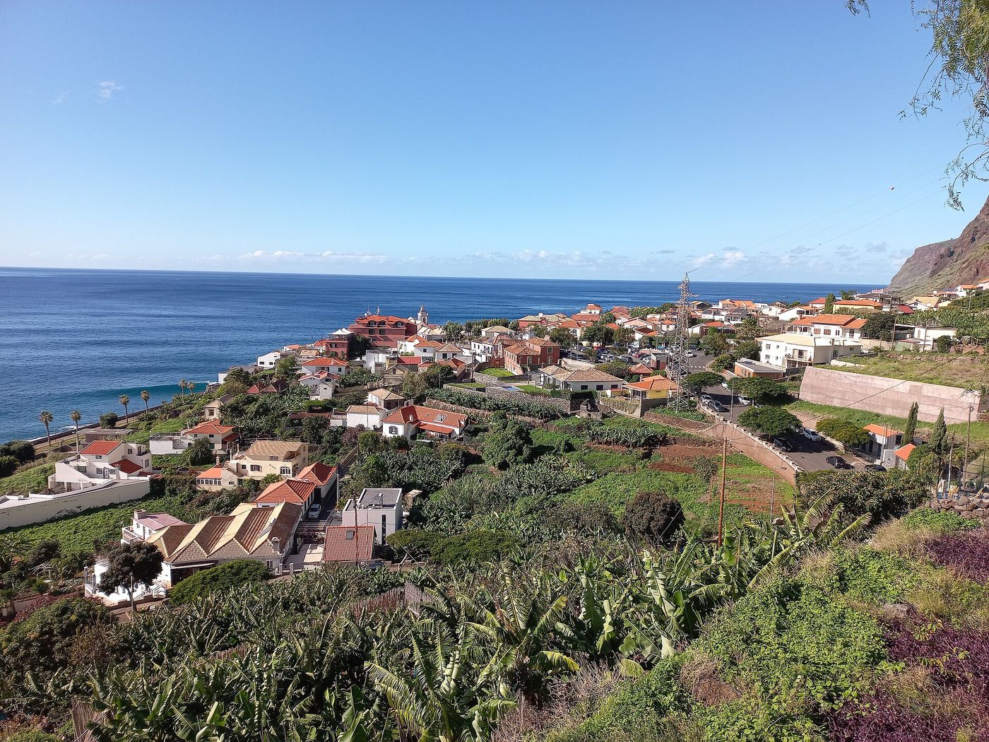Jardim do Mar on Madeira, with red-roofed houses, cultivated plots and a church tower beside the Atlantic.