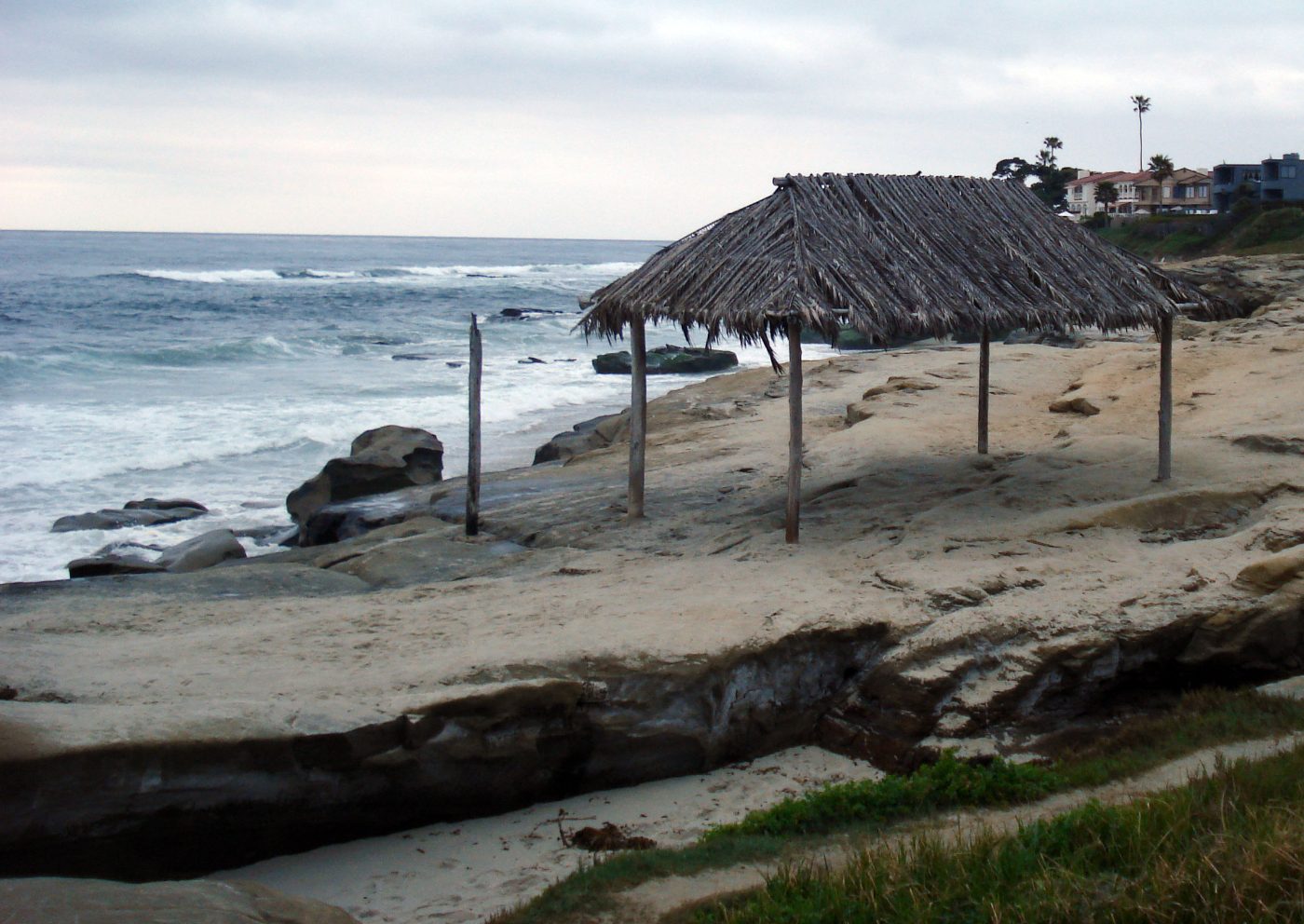 Palm-covered Windansea Surf Shack on coastal rocks beside the ocean in La Jolla, photographed in 2008.
